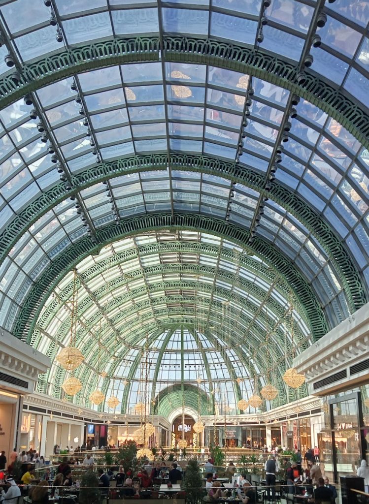 Stunning view of a glass roof inside a bustling Dubai shopping mall.