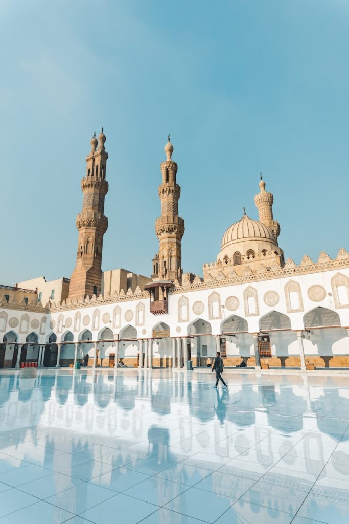 people walking near white concrete building during daytime Al-Azhar Mosque, El-Darb El-Ahmar, Egypt