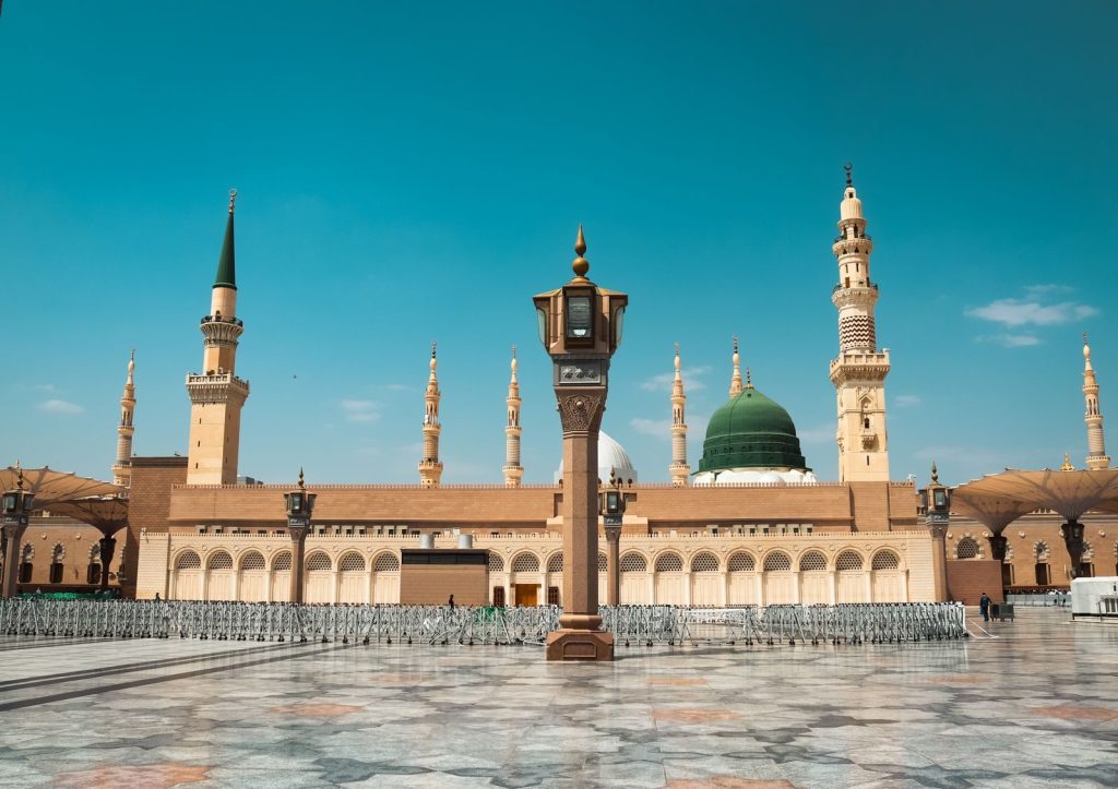 Stunning view of Al-Masjid an-Nabawi with its iconic green dome and minarets in Madinah, Saudi Arabia.
